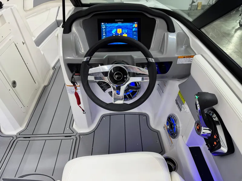 Slide: The Image of 2025 Chaparral 21 Surf boat cockpit with modern steering and digital display. - 14