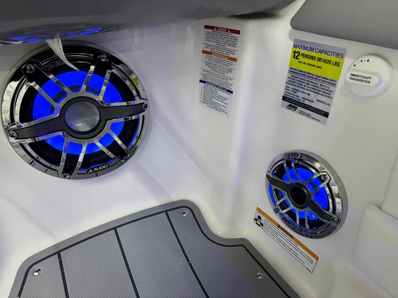 Slide: The Image of 2025 Chaparral 21 Surf boat interior with blue LED speakers and capacity labels. - 15