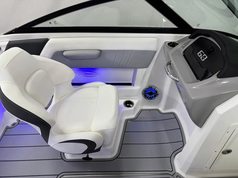 Slide: The Image of Interior of 2025 Chaparral 21 Surf boat with white seating and blue LED lighting. - 19
