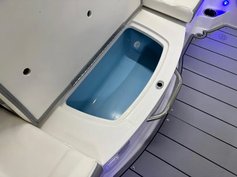Slide: The Image of 2025 Chaparral 21 Surf boat interior with open storage compartment. - 24