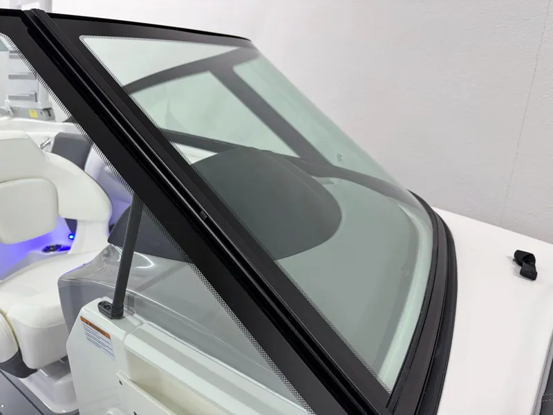 Slide: The Image of 2025 Chaparral 21 Surf boat windshield and interior seating detail. - 36