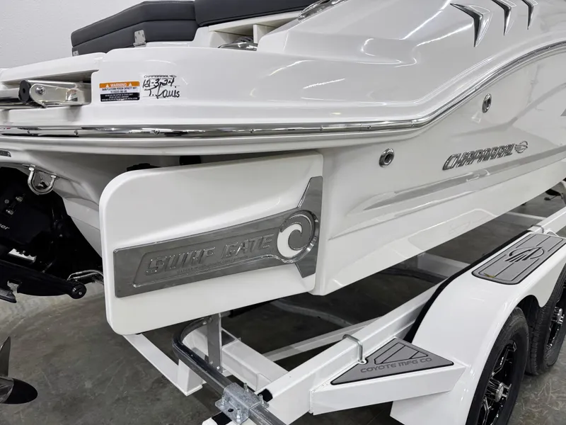 Slide: The Image of 2025 Chaparral 21 Surf boat on trailer, featuring sleek white design and logo details. - 4