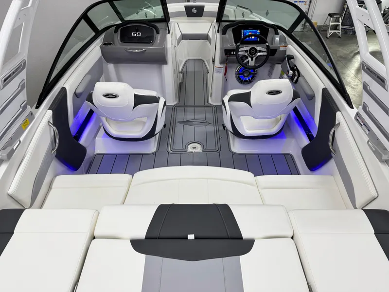 Slide: The Image of 2025 Chaparral 21 Surf boat interior with modern seating and blue LED lighting. - 9