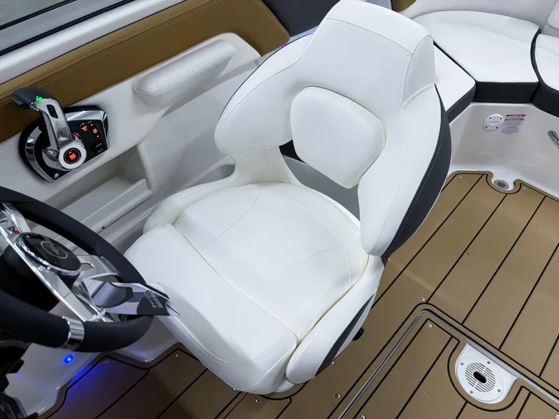 Slide: The Image of 2025 Chaparral 23 SSi boat interior with white captain's chair and modern controls. - 12