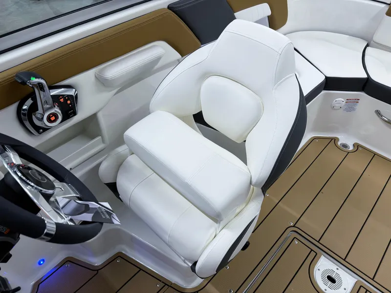 Slide: The Image of 2025 Chaparral 23 SSi boat interior with white captain's chair and modern controls. - 13