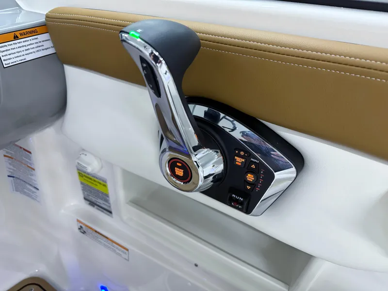 Slide: The Image of 2025 Chaparral 23 SSi boat throttle control with chrome finish and ergonomic design. - 14