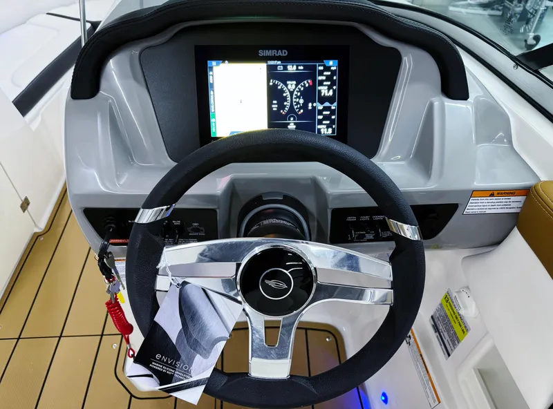 Slide: The Image of 2025 Chaparral 23 SSi boat dashboard with steering wheel and digital display. - 15
