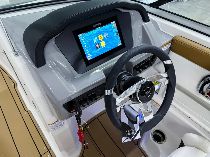 Slide: The Image of 2025 Chaparral 23 SSi boat dashboard with touchscreen and steering wheel. - 16