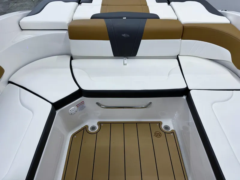 Slide: The Image of 2025 Chaparral 23 SSi boat interior with white and tan seating, sleek design. - 19