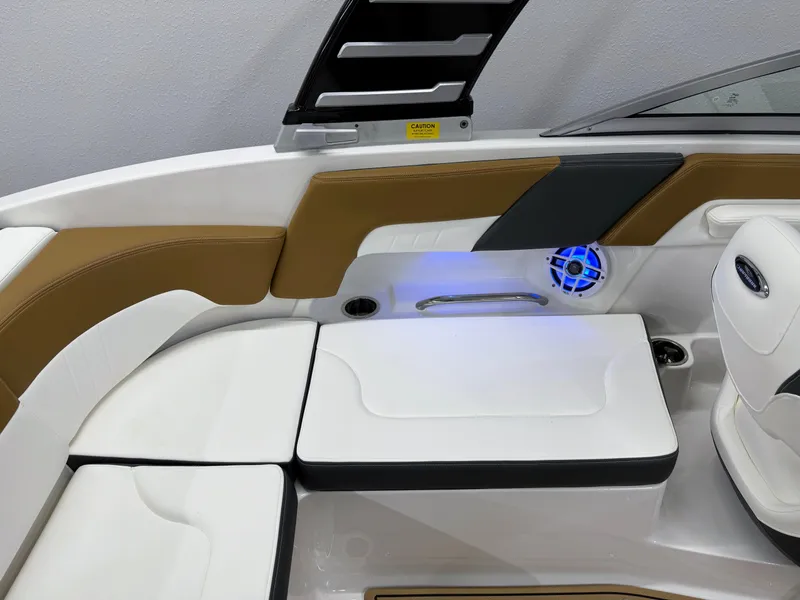 Slide: The Image of 2025 Chaparral 23 SSi boat interior with white seating and blue LED lighting. - 22