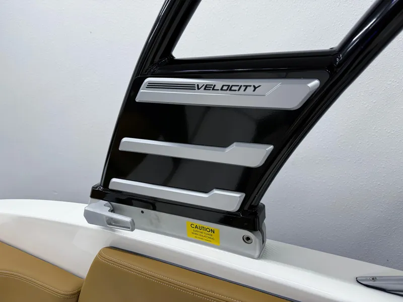 Slide: The Image of 2025 Chaparral 23 SSi boat detail with Velocity branding and caution label. - 23