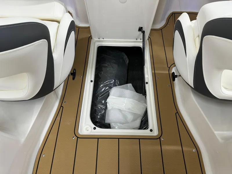 Slide: The Image of 2025 Chaparral 23 SSi boat interior storage compartment with open hatch. - 27