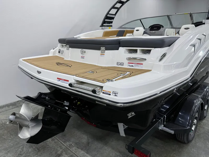 Slide: The Image of 2025 Chaparral 23 SSi boat, rear view, showcasing sleek design and powerful engine. - 3