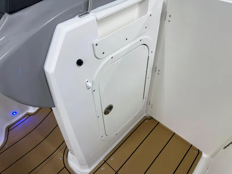 Slide: The Image of 2025 Chaparral 23 SSi boat interior with white hatch and teak flooring. - 31
