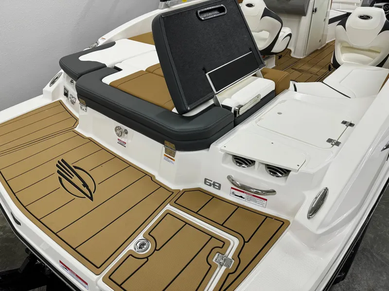 Slide: The Image of 2025 Chaparral 23 SSi boat interior with tan and white seating and deck. - 5