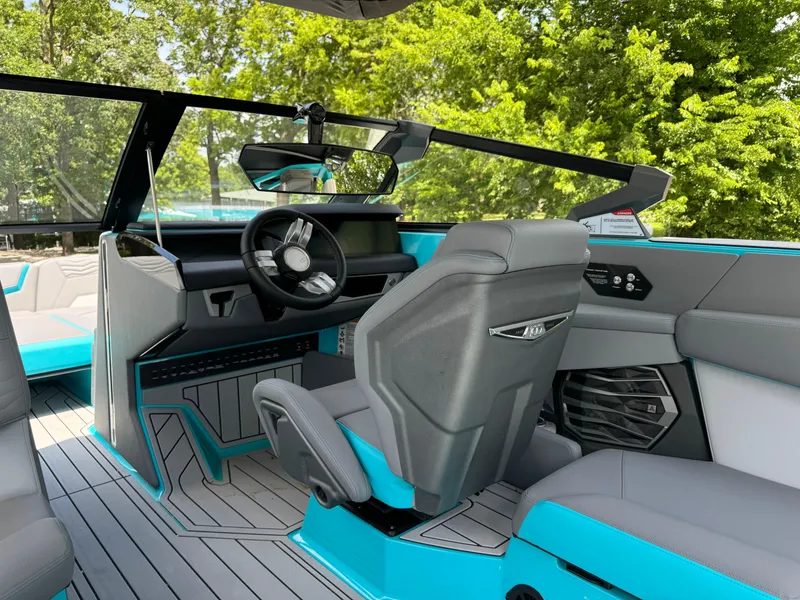 Slide: The Image of Interior of 2025 Nautique G25 boat with modern design and turquoise accents. - 15