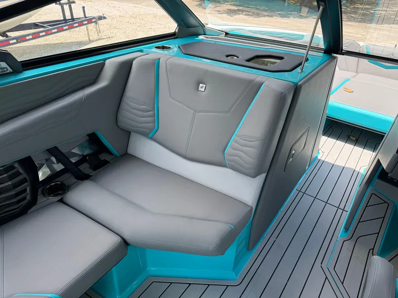 Slide: The Image of 2025 Nautique G25 interior with gray and teal seating, modern design, and sleek finishes. - 16