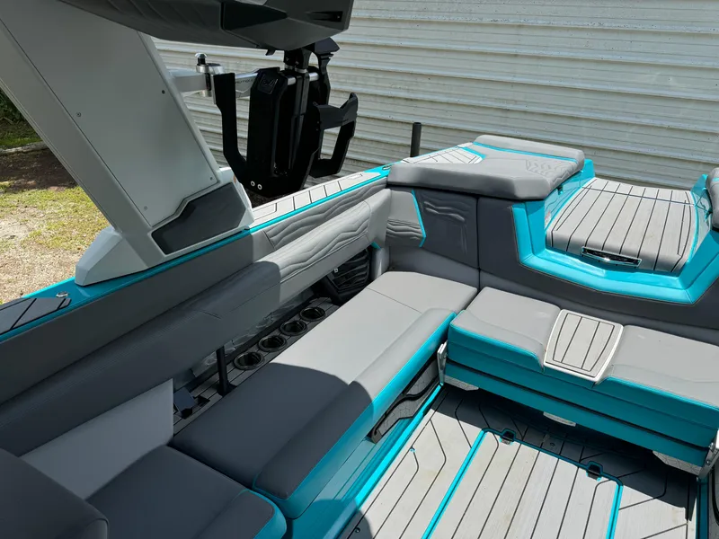 Slide: The Image of 2025 Nautique G25 boat interior with gray and teal seating, modern design. - 20