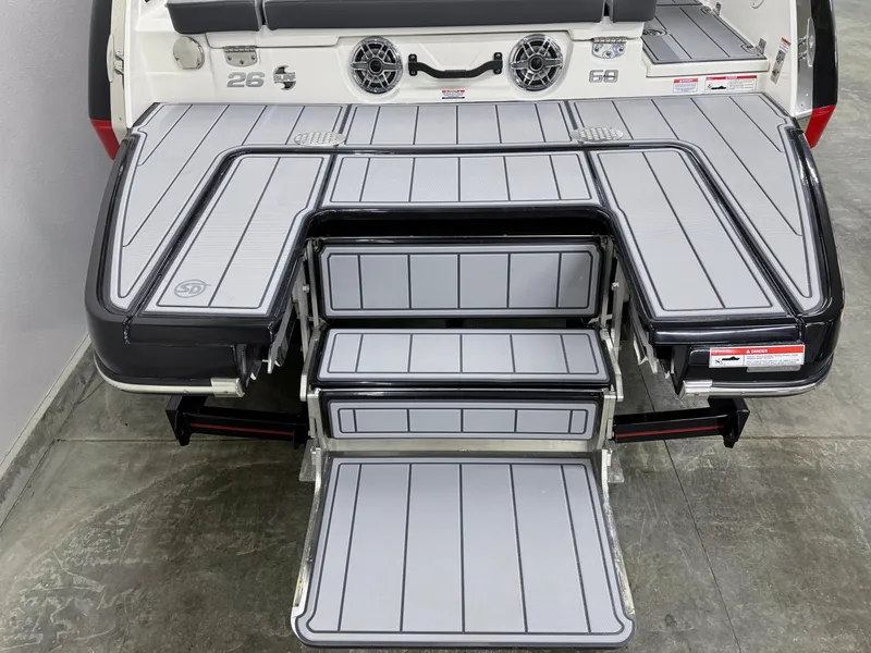 Slide: The Image of 2025 Chaparral 26 Surf boat with sleek swim platform and integrated steps. - 10