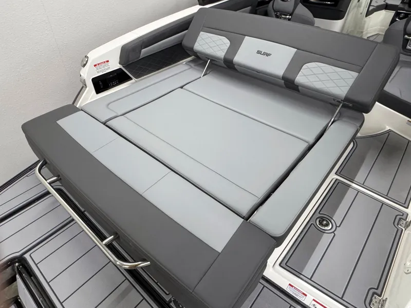 Slide: The Image of 2025 Chaparral 26 Surf boat interior with gray cushioned seating. - 13