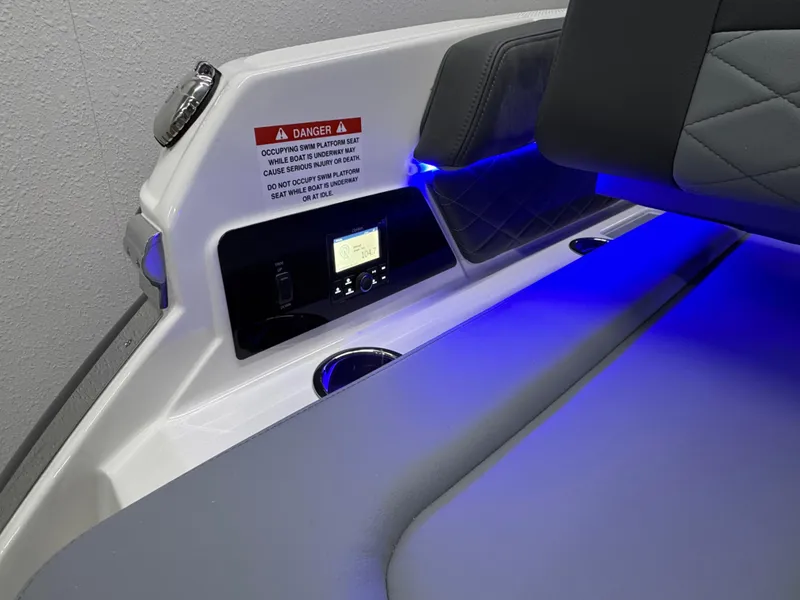Slide: The Image of 2025 Chaparral 26 Surf boat interior with blue LED lighting and control panel. - 14