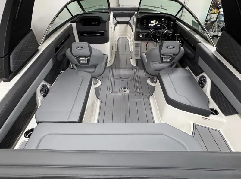 Slide: The Image of 2025 Chaparral 26 Surf boat interior with sleek gray seating and modern dashboard. - 15