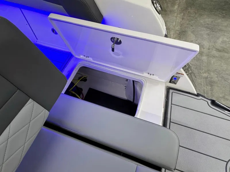 Slide: The Image of 2025 Chaparral 26 Surf boat storage compartment with blue LED lighting. - 18