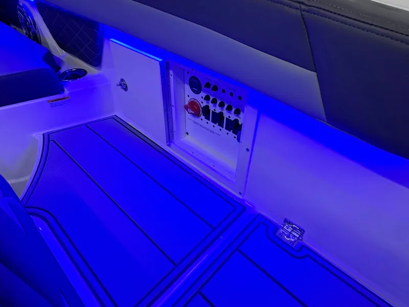 Slide: The Image of 2025 Chaparral 26 Surf interior with blue LED lighting and control panel. - 19