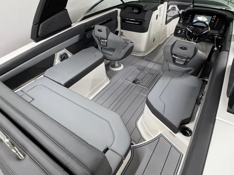 Slide: The Image of 2025 Chaparral 26 Surf boat interior with sleek gray seating and modern dashboard. - 20