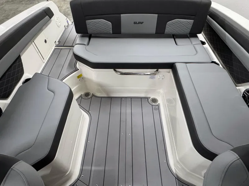 Slide: The Image of 2025 Chaparral 26 Surf boat interior with gray seating and flooring. - 31