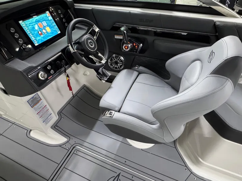 Slide: The Image of 2025 Chaparral 26 Surf boat interior with modern dashboard and comfortable seating. - 33