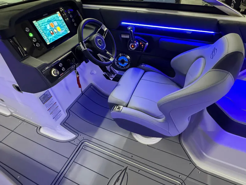Slide: The Image of 2025 Chaparral 26 Surf boat interior with modern dashboard and illuminated controls. - 34