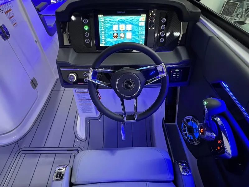 Slide: The Image of 2025 Chaparral 26 Surf boat cockpit with modern steering and digital display. - 35