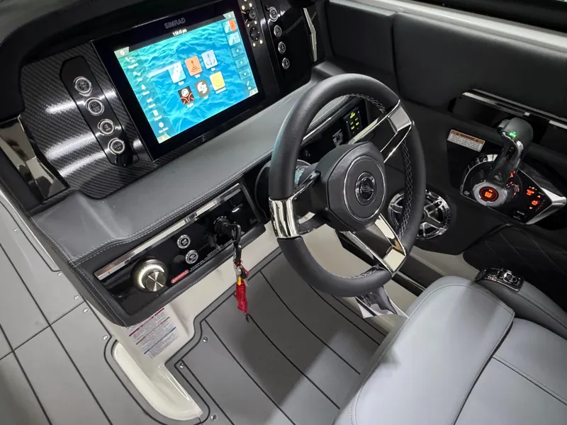Slide: The Image of 2025 Chaparral 26 Surf boat cockpit with modern dashboard and steering wheel. - 36