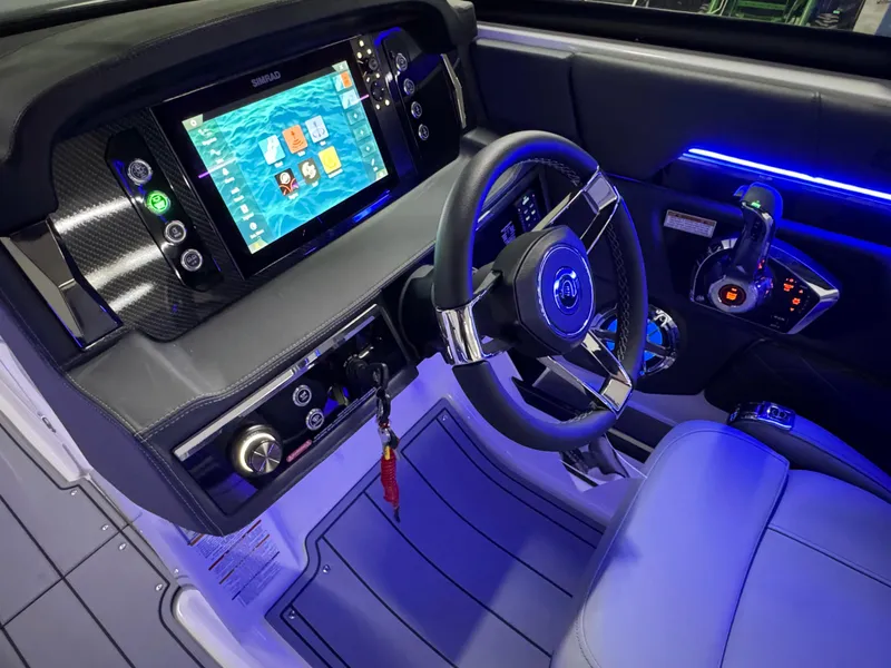 Slide: The Image of 2025 Chaparral 26 Surf boat interior with modern dashboard and steering wheel. - 37