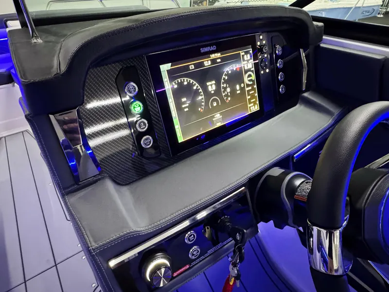 Slide: The Image of 2025 Chaparral 26 Surf dashboard with digital display and controls, featuring modern design elements. - 38