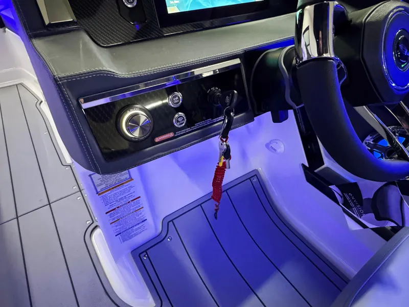 Slide: The Image of 2025 Chaparral 26 Surf boat dashboard with steering wheel and control panel. - 40