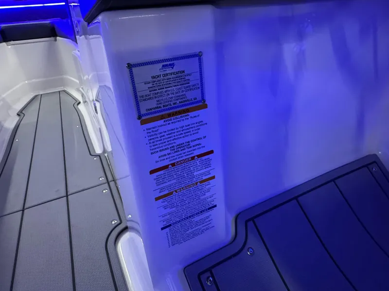 Slide: The Image of 2025 Chaparral 26 Surf boat interior with blue lighting and safety instructions. - 41
