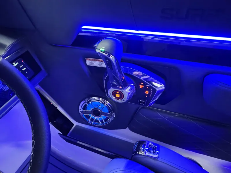 Slide: The Image of Interior of 2025 Chaparral 26 Surf boat with illuminated controls and speaker. - 43