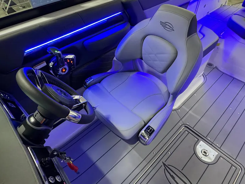 Slide: The Image of 2025 Chaparral 26 Surf boat interior with illuminated controls and luxurious seating. - 45