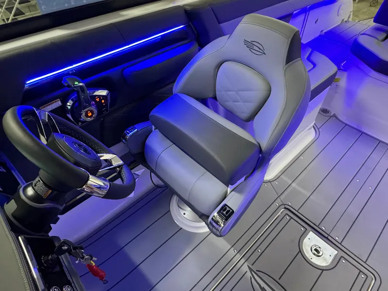 Slide: The Image of 2025 Chaparral 26 Surf boat interior with modern steering and seating. - 46