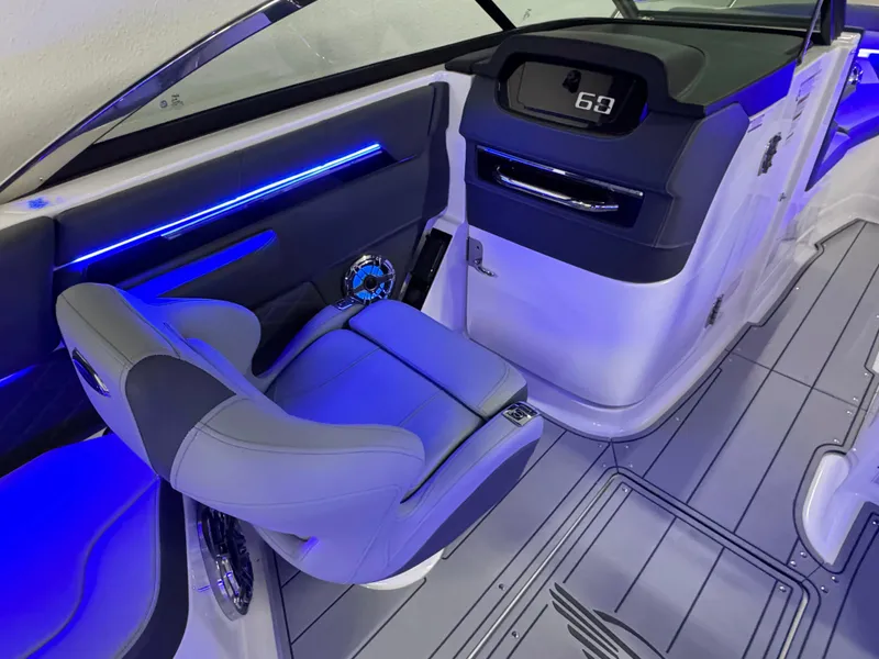 Slide: The Image of 2025 Chaparral 26 Surf boat interior with modern dashboard and blue LED lighting. - 47