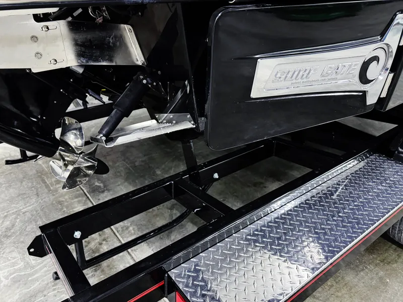 Slide: The Image of 2025 Chaparral 26 Surf boat trailer with metal step and propeller detail. - 5