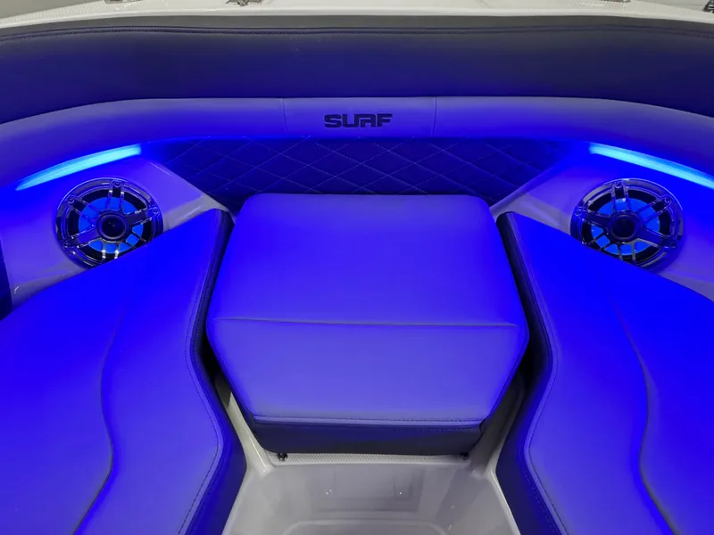 Slide: The Image of 2025 Chaparral 26 Surf boat interior with blue LED lighting and premium seating. - 57