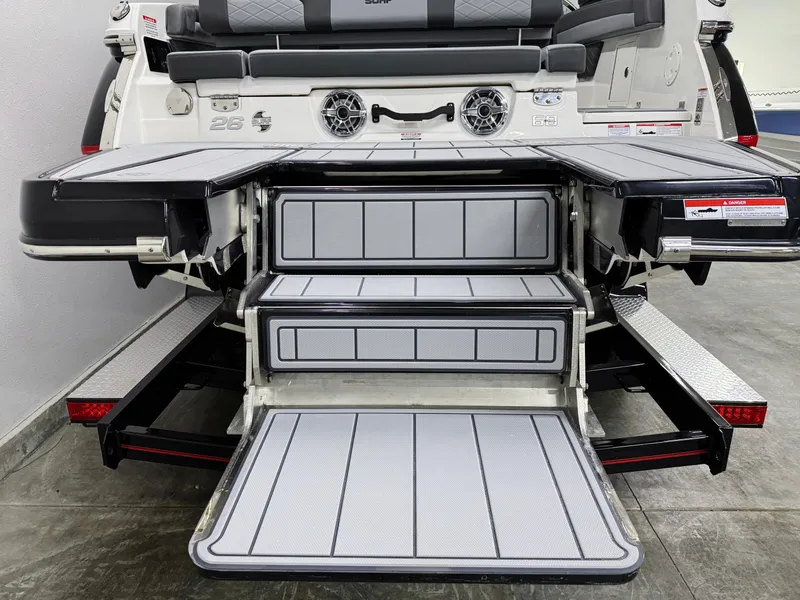 Slide: The Image of 2025 Chaparral 26 Surf boat with extended swim platform and steps. - 7
