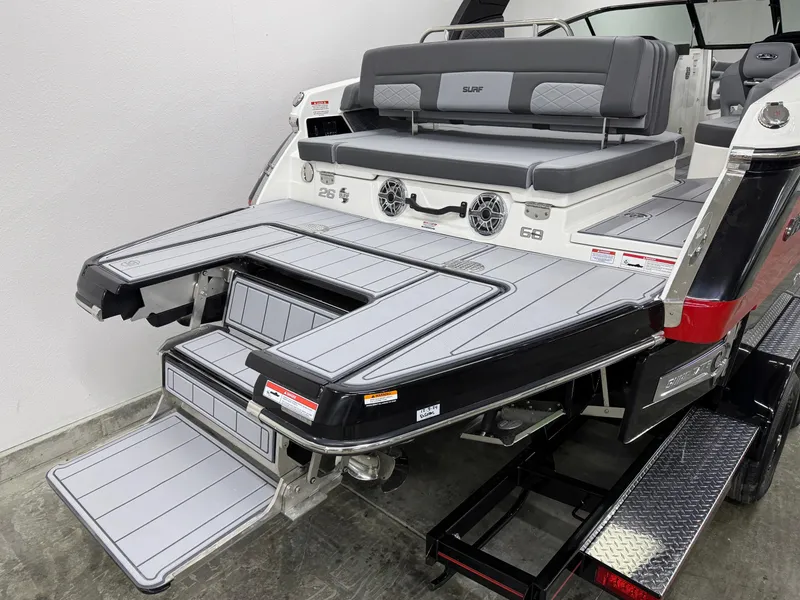 Slide: The Image of 2025 Chaparral 26 Surf boat with sleek swim platform and seating area. - 9