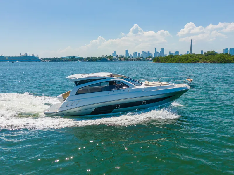 Slide: The Image of 2025 Hanover 375 Outboard cruising on a sunny day with city skyline in background. - 5