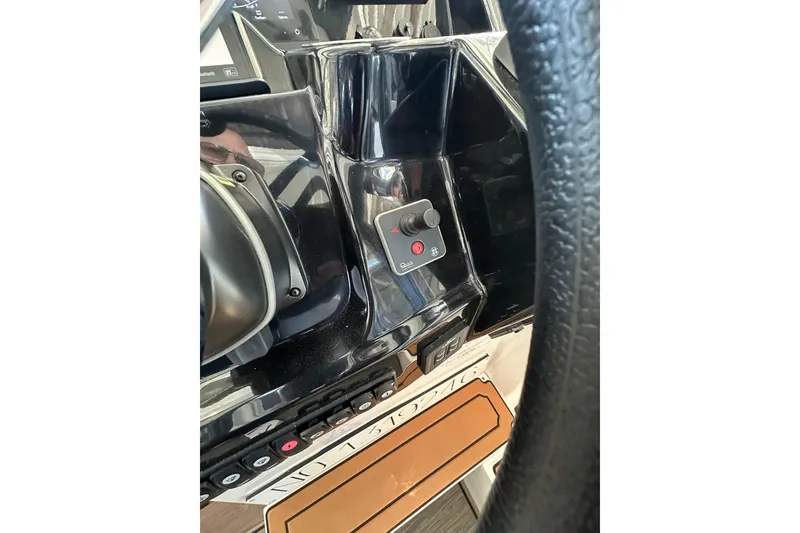 Slide: The Image of Control panel of a 2021 Jeanneau NC 895 boat, featuring a joystick and switches. - 20