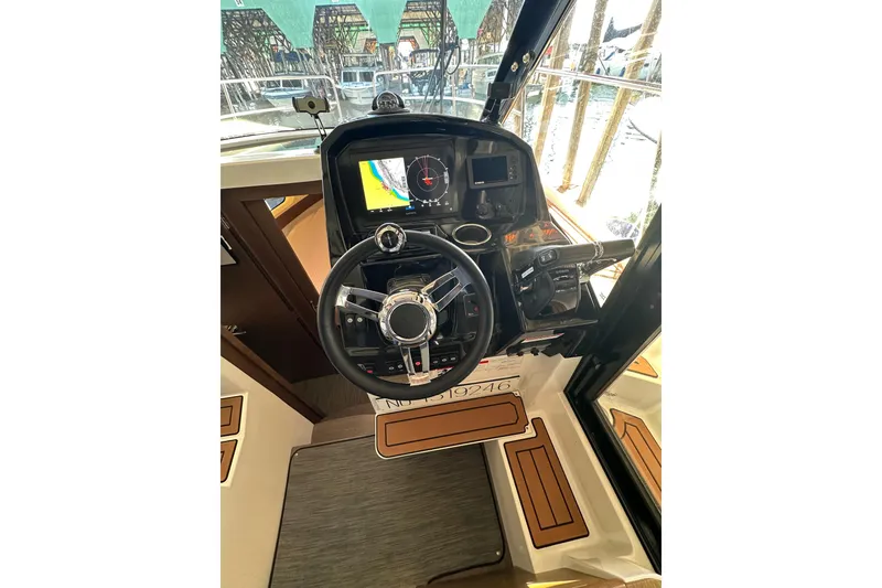 Slide: The Image of 2021 Jeanneau NC 895 helm with steering wheel and navigation display. - 23