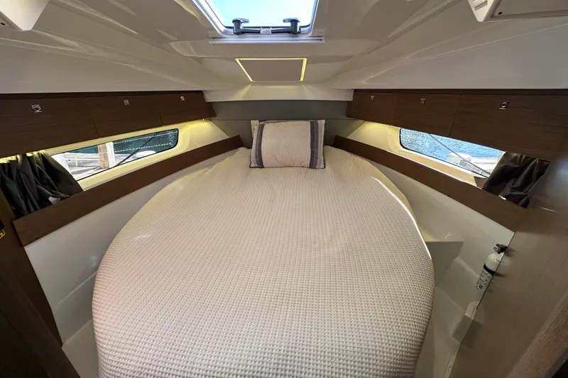 Slide: The Image of 2021 Jeanneau NC 895 cabin interior with cozy bed and natural light. - 24